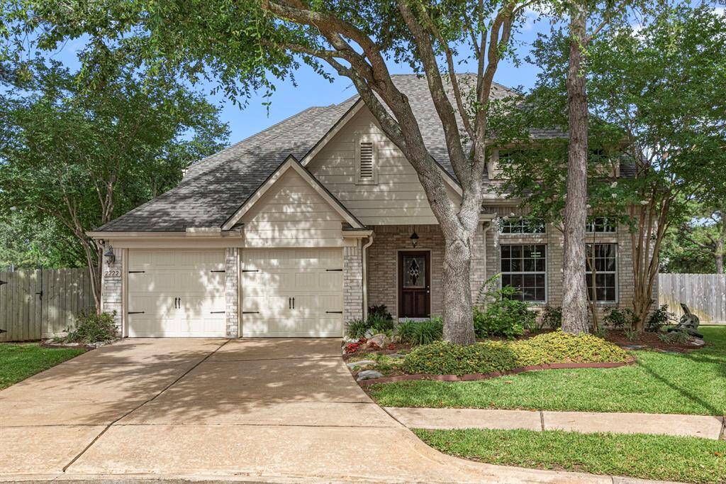 Charming curb appeal w/welcoming front facade shaded by mature trees, offering natural beauty and year-round character.