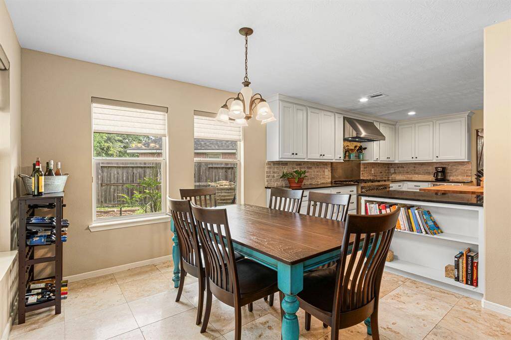The breakfast nook offers a warm, comfortable place to start your day, with windows overlooking the backyard that bring in soft natural light and a  touch of the outdoors.