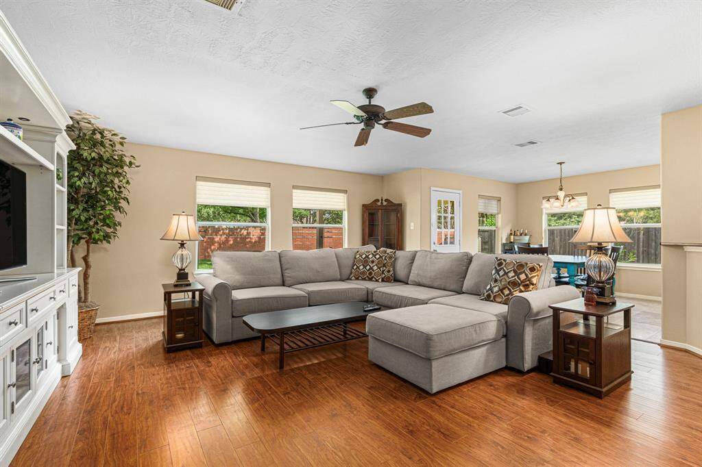 Designed for both everyday living and entertaining, the family room has ample space for a large media cabinet and windows that overlook the spacious backyard, connecting indoor comfort with outdoor beauty.