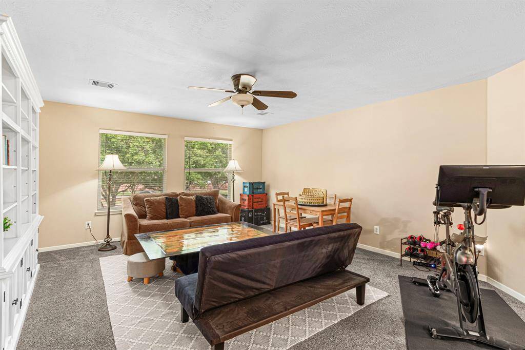 At the top of the stairs, an inviting and spacious game room awaits--with generous windows for natural light, and ample space for a game table or lounge seating.