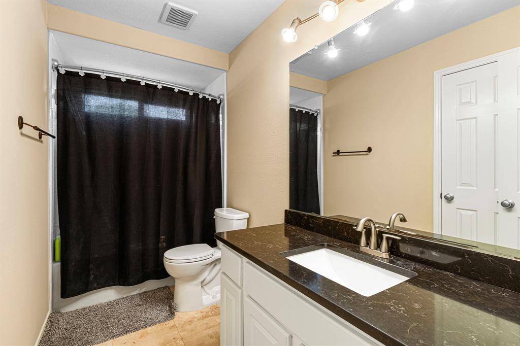 This centrally located bathroom offers seamless access from the game room, media room and secondary bedroom.