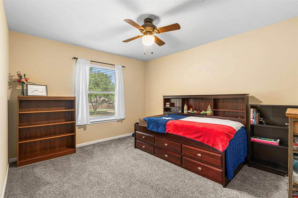 Also located at the front of the home, this secondary bedroom features a large window an a comfortable footprint, suited for a variety of uses from sleep to study.