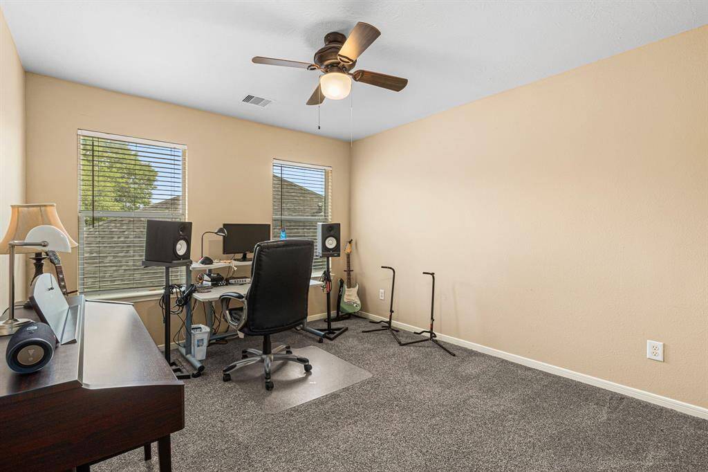 The third upstairs bedroom offers flexible functionality--perfect as a guest room, hobby space, or  creative studio.