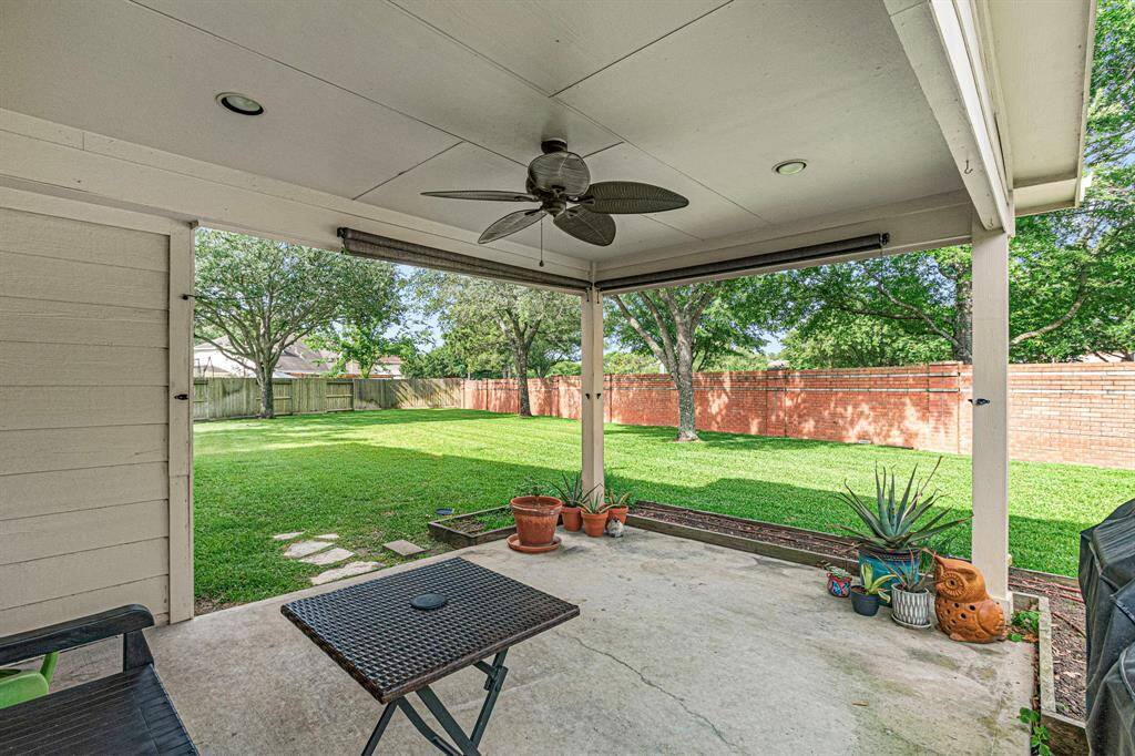 Step just outside the breakfast area onto a large covered porch--perfect for outdoor dining or relaxing while overlooking the expansive backyard.