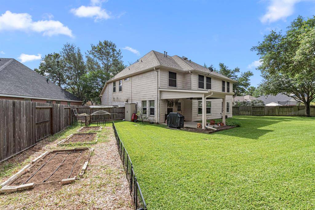 The backyard features dedicated organic vegetable planting beds with drip irrigation and a 3-stage compost system, along one side--perfect for growing herbs, veggies, or flowers at home. The 2 storage sheds keep gardening tools tucked away.