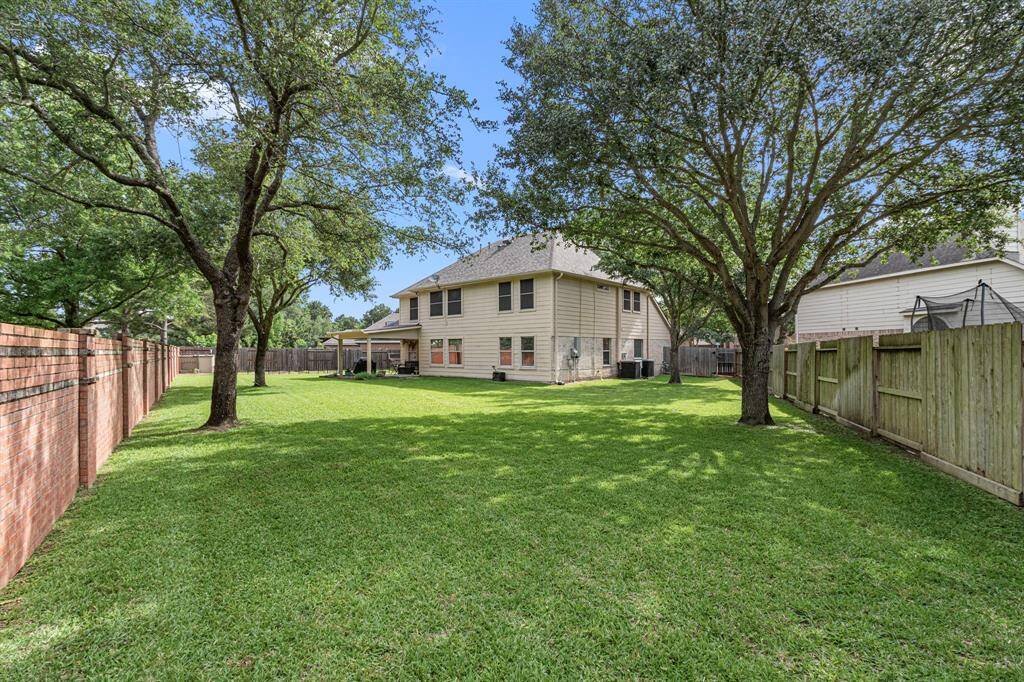 The oversized backyard is perfect for families and pet lovers alike, offering room for a pool, play structures, and ample green space for pets to enjoy.