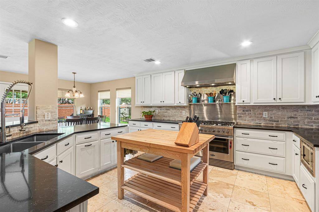 Another look at the kitchen showcases its impressive amount of cabinet space, offering both upper and lower storage to support a clutter-free, highly functional cooking environment.