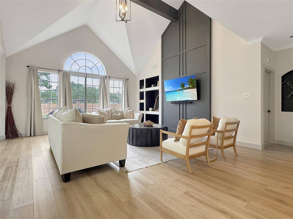 Gorgeous Flooring, custom built ins and natural lighting making this space perfect for entertaining!