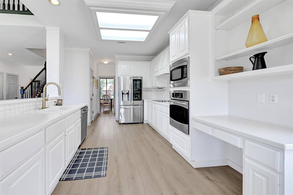 This view from the kitchen looks toward the front formal dining room, passing a spacious pantry and convenient utility room along the way.