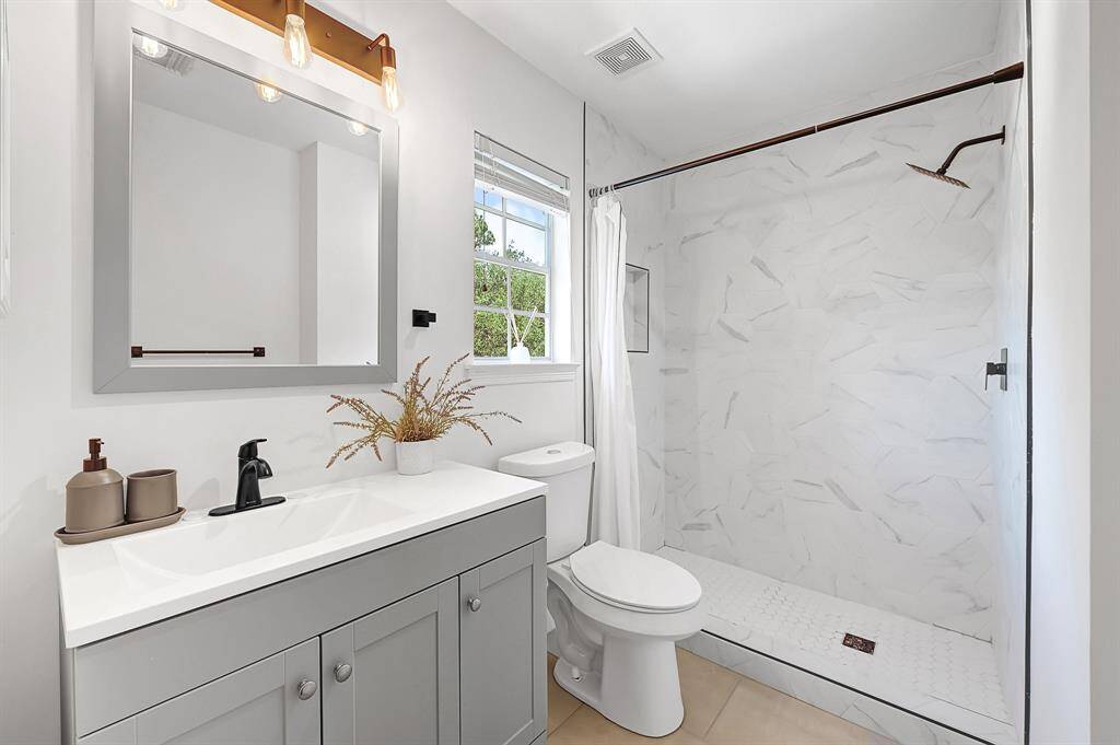 Upstairs bathroom measuring 5'8" x 9'5" features large vanity and walk-in shower.