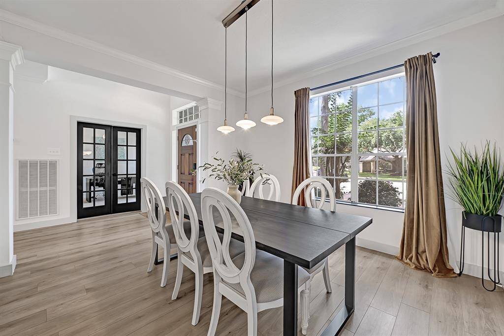 Formal dining room with a view toward the foyer and study room beyond.