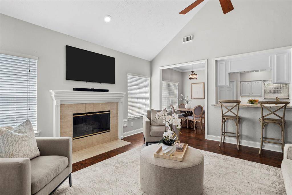 With views into the kitchen and breakfast room, this light-filled family room offers an ideal open-concept layout designed for effortless entertaining and daily living.