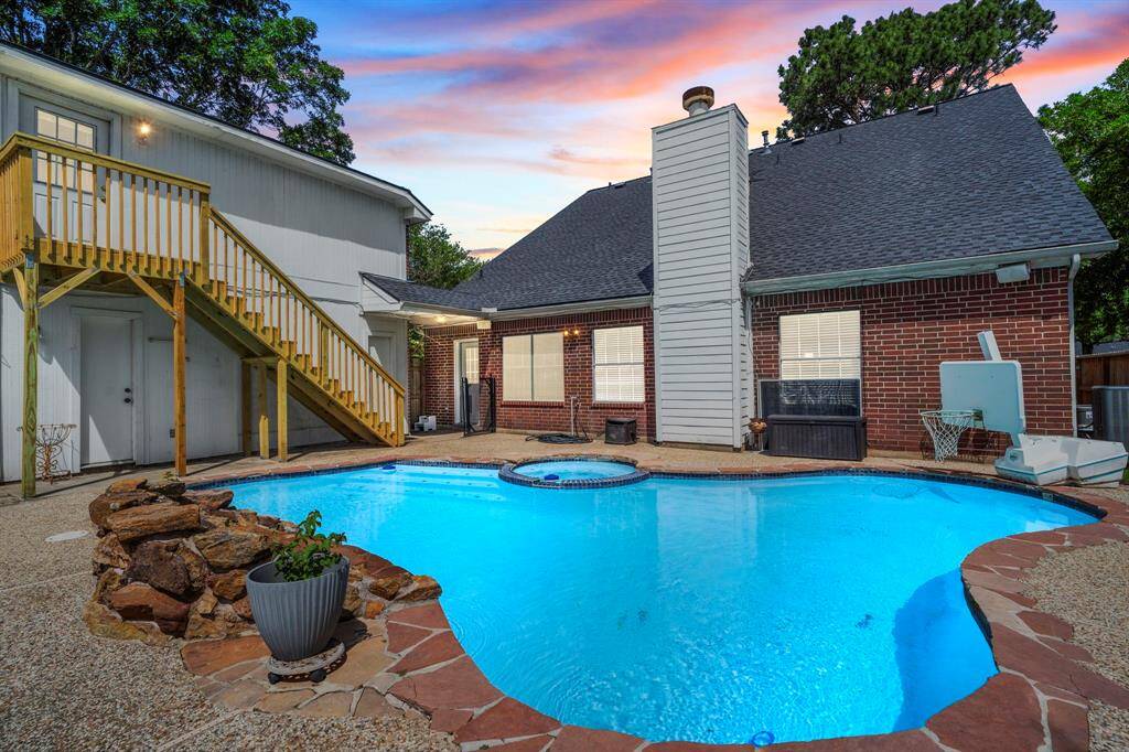 This inviting backyard offers a peaceful setting with a sparkling pool, relaxing spa, and plenty of space to lounge, unwind, or entertain in comfort.