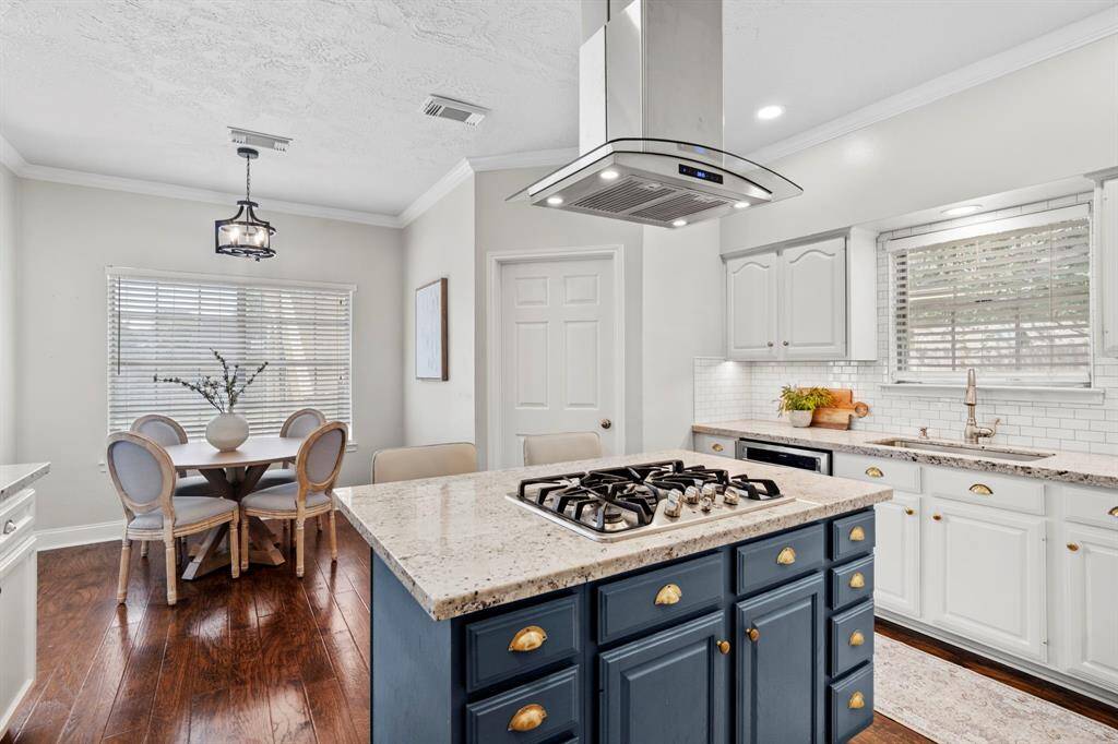 Just off the kitchen, the sunny breakfast area provides the perfect spot to enjoy morning coffee or casual meals with views of the backyard.