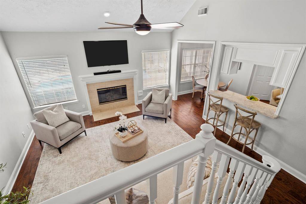 From the landing, enjoy a sweeping view of the bright and airy family room below, featuring a cozy fireplace and seamless flow into the breakfast area and kitchen.