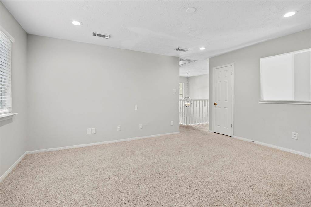 The upstairs game room offers generous space for entertaining, relaxing, or working from home, with access to a full bathroom and a private entry.