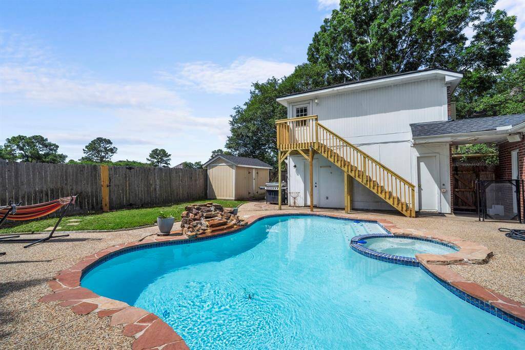 This sparkling pool and attached spa offer the perfect place to unwind, complete with a rock waterfall feature and plenty of space for poolside seating.