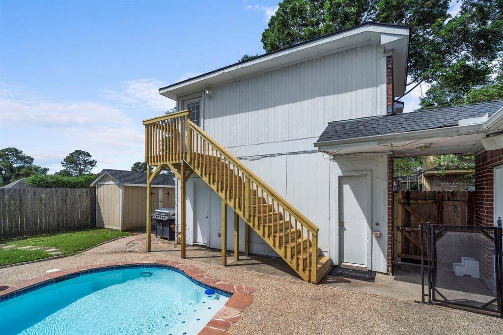 Enjoy your private retreat with a poolside grill area, green space for games, and easy access to the upstairs garage apartment.