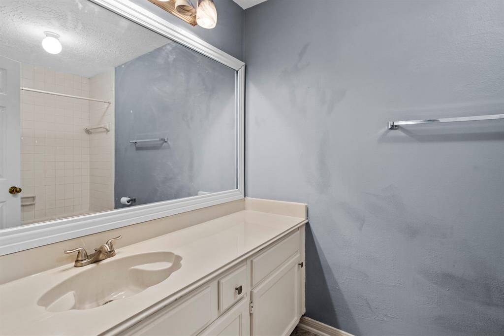 The full bath features a wide vanity, large mirror, and plenty of storage, ready for everyday use or weekend stays.