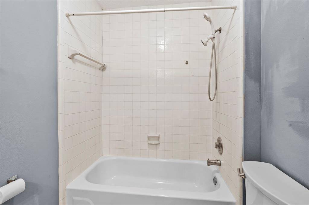 A classic tub/shower combination offers functionality and convenience in this private apartment bath.