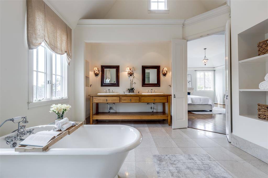 Spacious bathroom also with vaulted ceilings and traditional pedestal tub, separate shower, and attached to large, walk-in master closet.