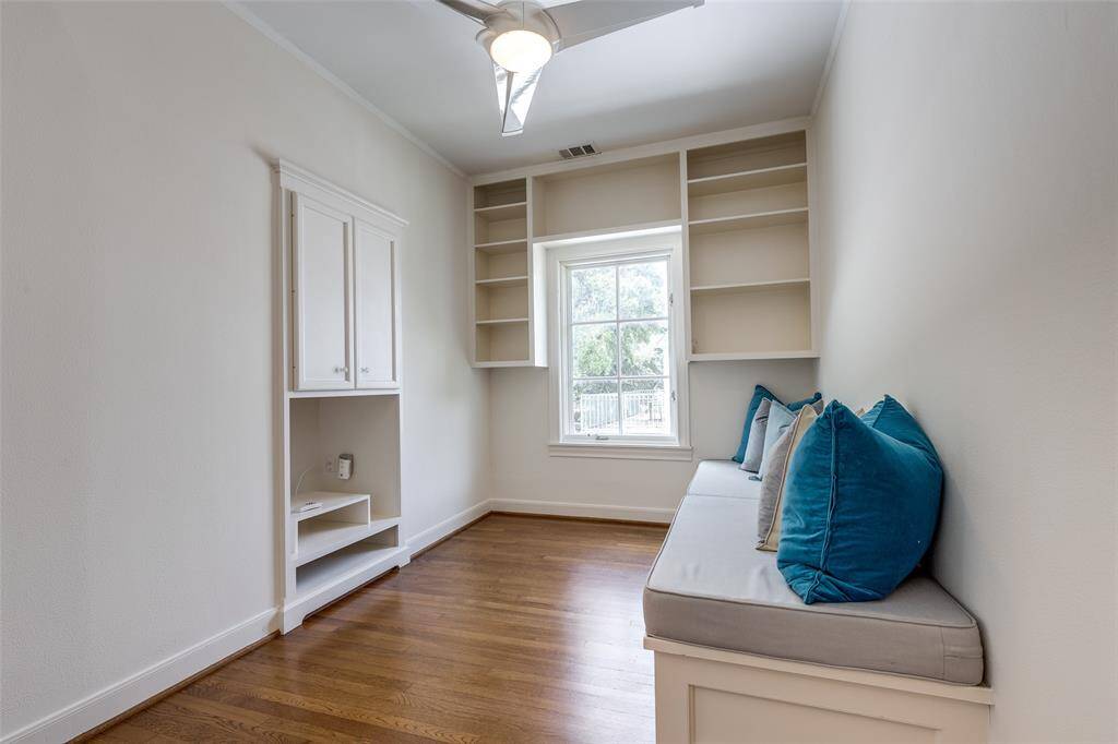 Cozy up with a book on this window seat with built-in storage with natural lighting