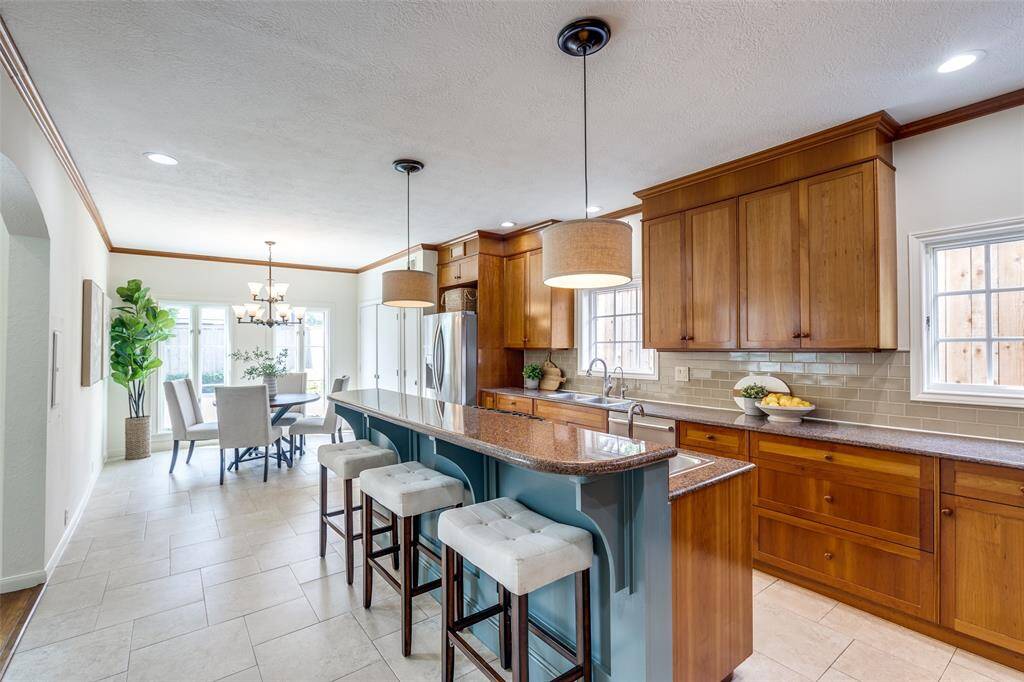 Kitchen featuring spacious refrigerator, water filtration system, and ample room for eating together as a family.
