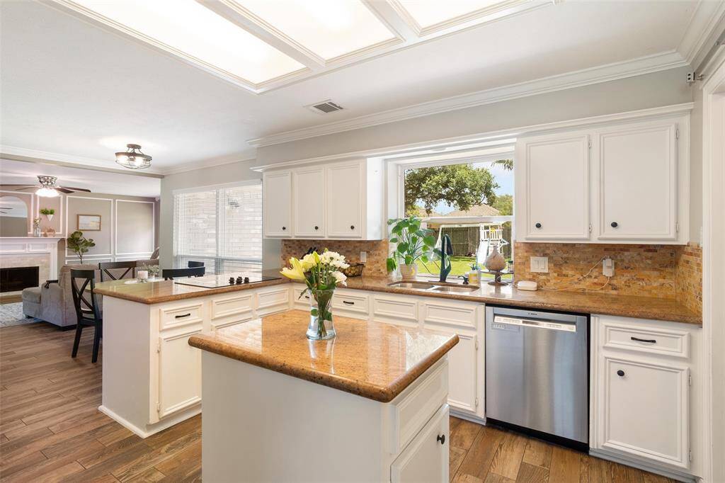 Island adding additional counter/storage space in this beautiful kitchen! Updated flooring throughout.