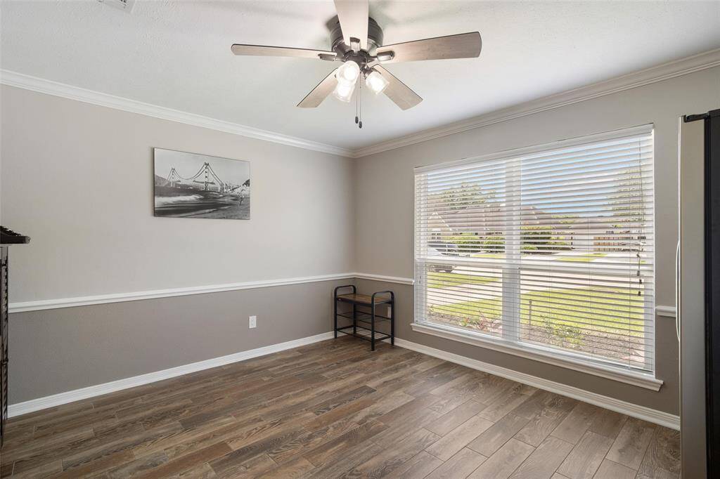 Dining room accented with chair rails and crown molding.