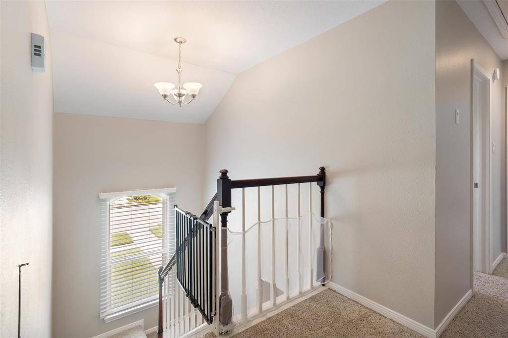 Window on stair landing lets in beautiful natural light to the staircase.