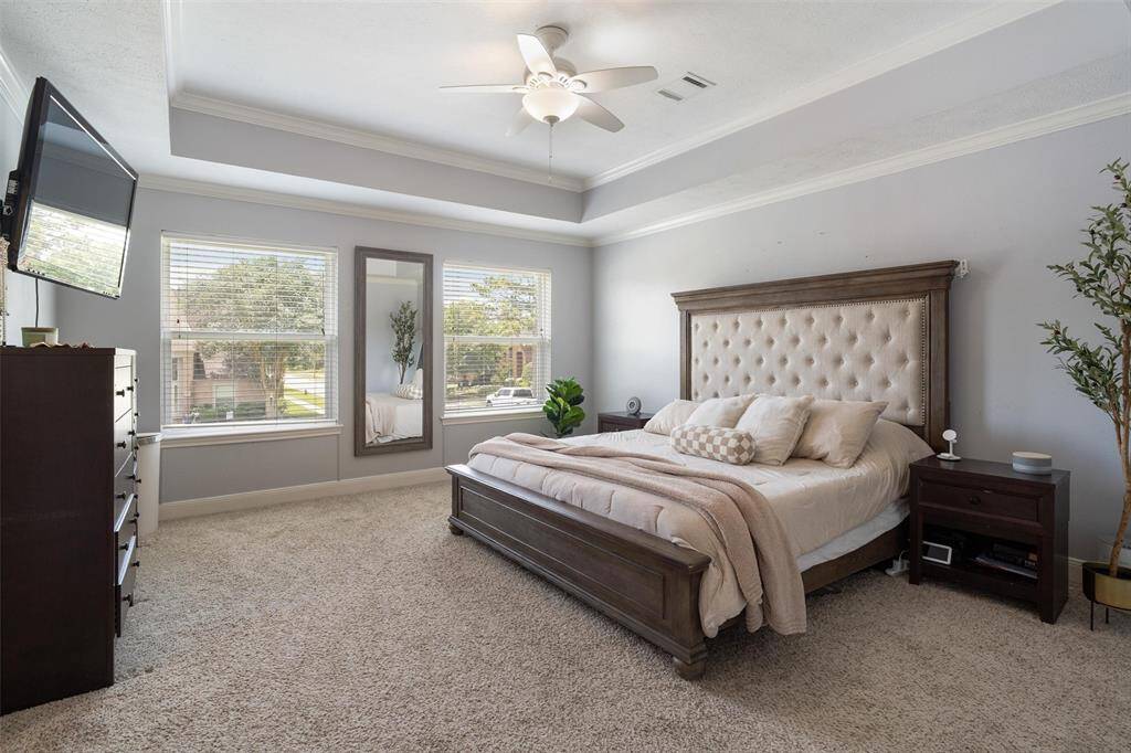 Primary bedroom with tray ceiling.