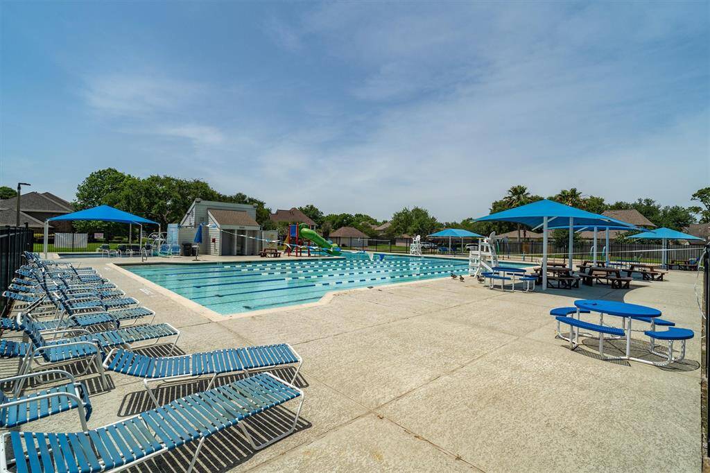 Community pool! Plenty of seating, and a water slide