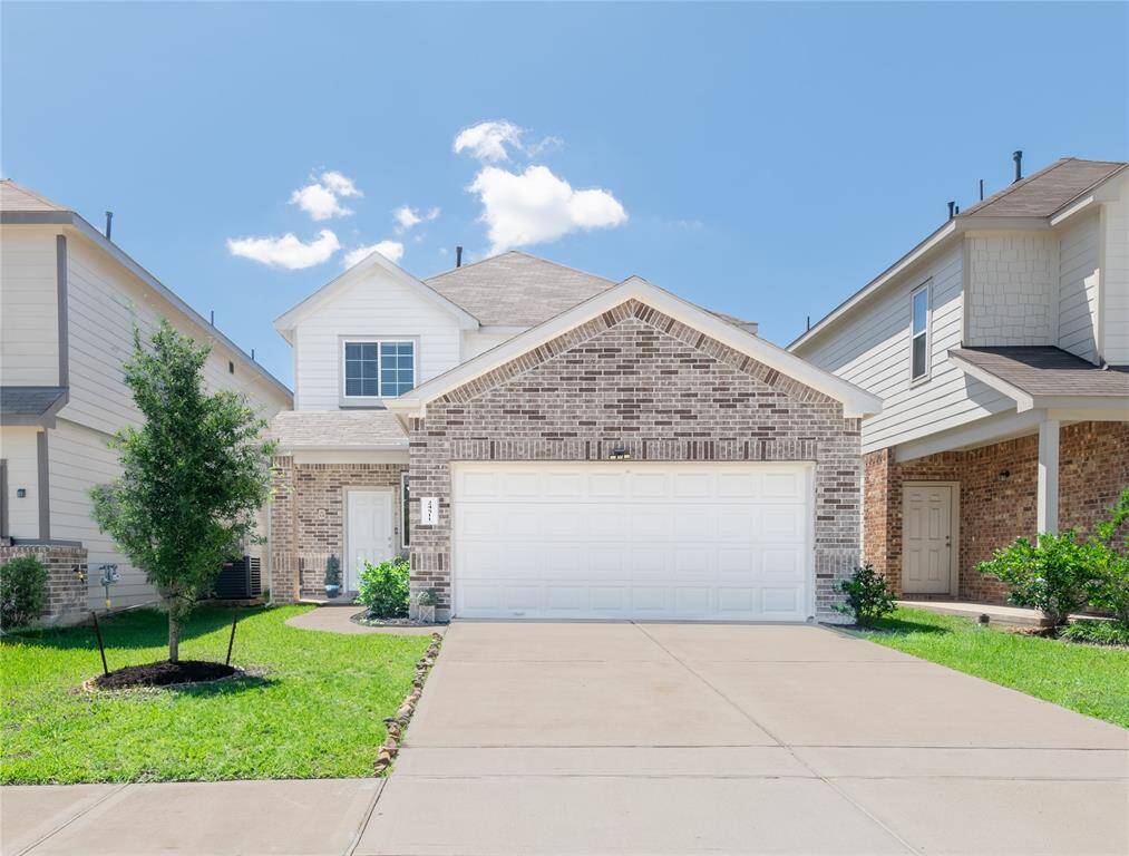 This beautifully maintained brick-front home welcomes you with a cozy porch.