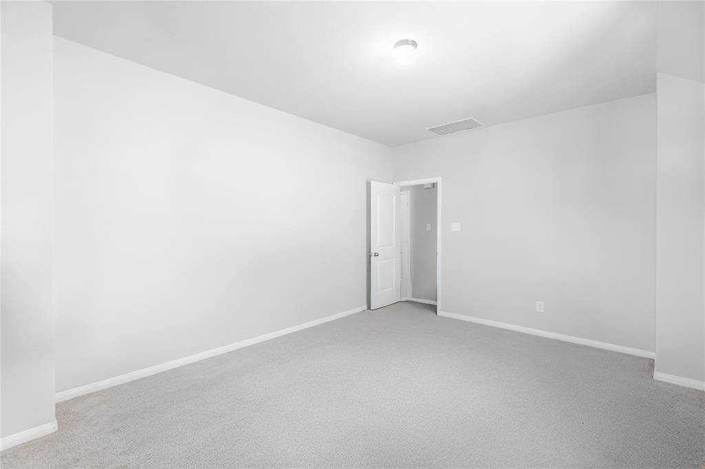 Actual furniture digitally removed, this spacious upstairs area offers tremendous flexibility—ideal as a fun-filled retreat, media room, or even a generously sized primary suite. *While the current photo showcases a bright, playful setup, please note that the actual room has standard lighting with a softer, yellow tone.