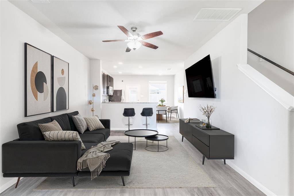 Digitally Staged! This spacious living room offers incredible potential with its open layout, and seamless flow into the kitchen and dining areas—perfect for creating your ideal gathering or relaxation space.