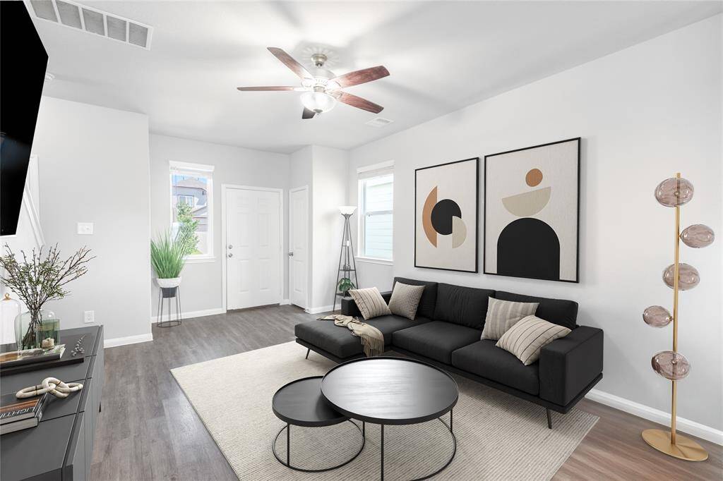 Digitally Staged! This spacious living room offers incredible potential with its open layout, and seamless flow into the kitchen and dining areas—perfect for creating your ideal gathering or relaxation space.