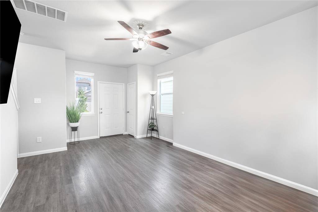 View of the Living Room to main entrance, imagine it transformed with updated lighting and personal touches.