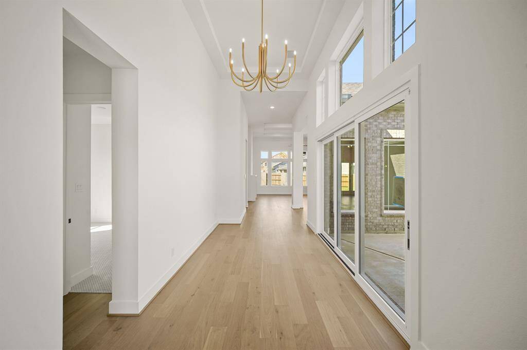 A spacious entryway, bathed in warm outdoor lighting that fills the room with a welcoming glow.