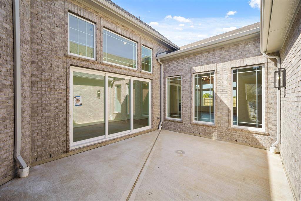 Charming courtyard with a seamless view into the elegant living and dining areas, blending indoor and outdoor beauty.
