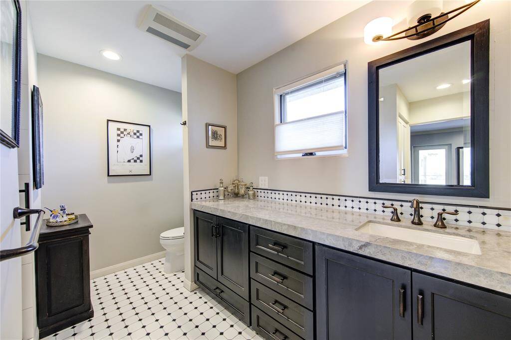 Hall bath located on the second floor with generous counter space, storage and step in shower to accommodate all your guests needs and all their things!
