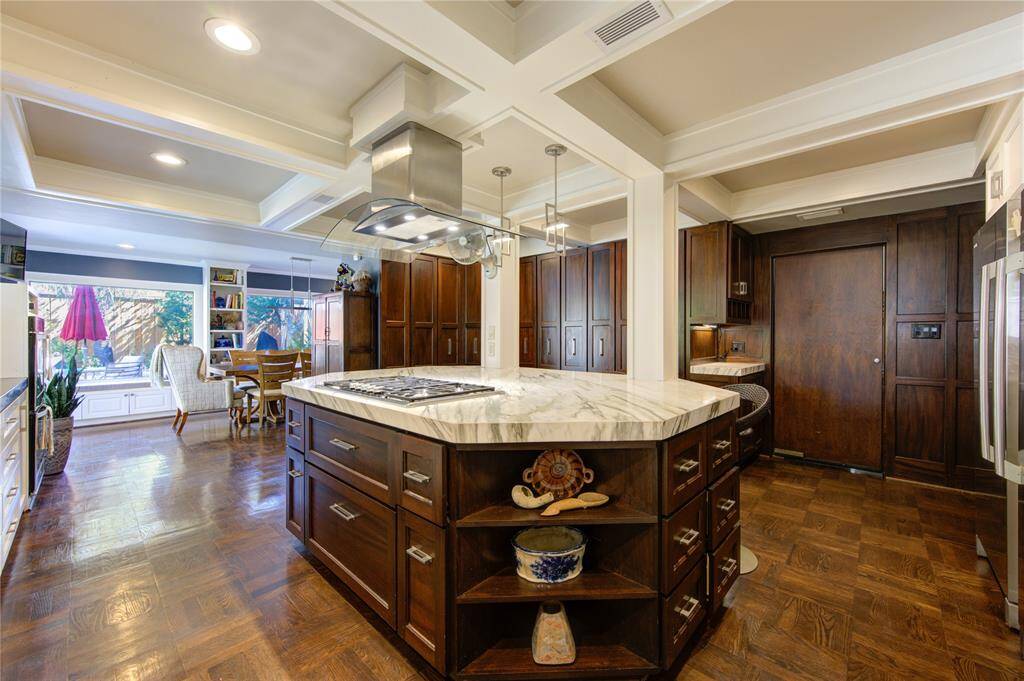Reimagined kitchen was opened up to include a modern cooking island with Thermidor gas cooktop, pots and pans drawers, storage on three sides and pull up seating.