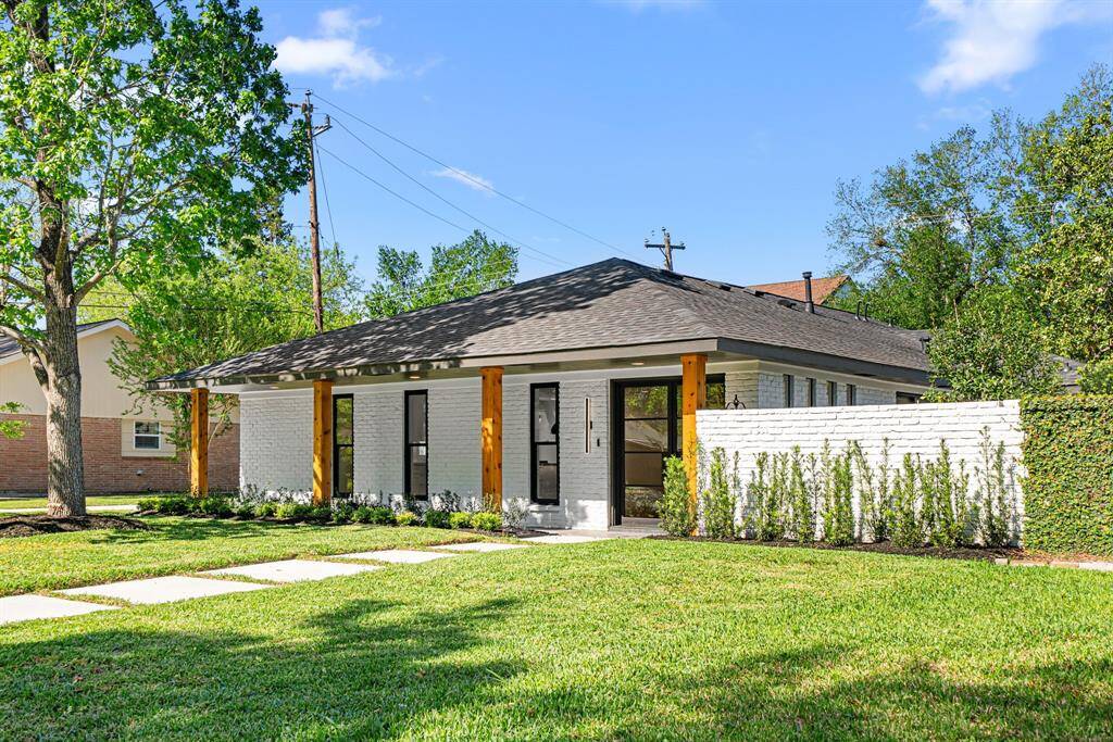 A statement-making entrance with elegant lighting and designer landscaping welcomes you home.