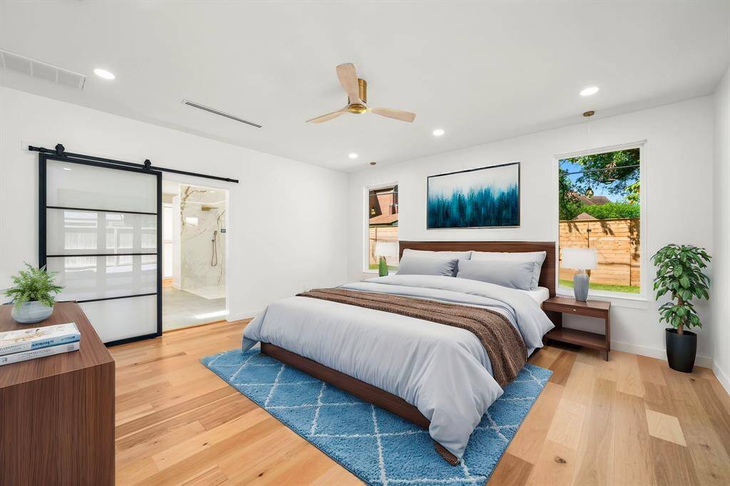 Grand Primary Suite Retreat – This expansive sanctuary boasts oversized proportions, elegant luxury glass panel doors, and seamless access to a private patio oasis for ultimate relaxation.