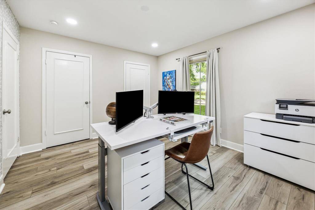 Inviting secondary bedroom featuring energy-efficient windows, elegant recessed lighting, and stylish luxury vinyl flooring.