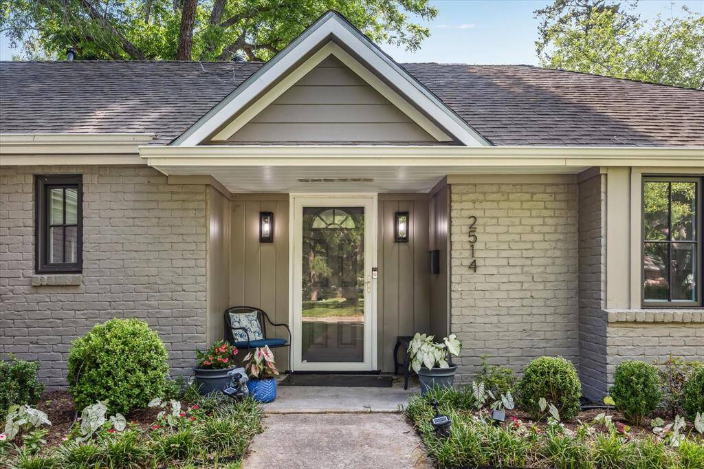 Charming home with a beautifully landscaped lot and inviting front porch.