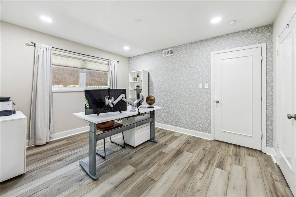 Another view of the secondary bedroom with designer wallpaper.