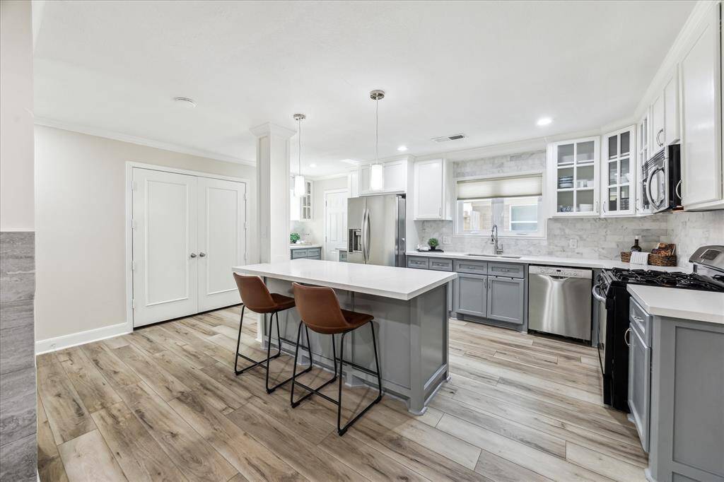 Expansive kitchen with abundant storage, featuring a spacious pantry, a convenient coffee nook, and direct driveway access for enhanced functionality.