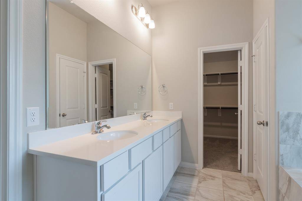 Primary bath with separate his and hers vanities