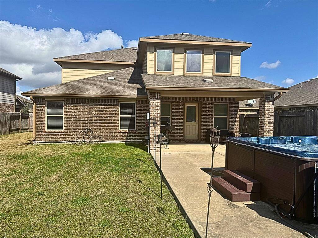 Large backyard with covered patio  and spa.