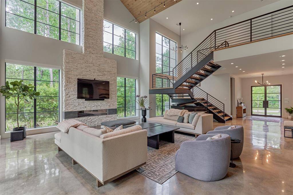 Comfortable yet elegant setting featuring cultured stone fireplace and built-in audio via the Heos system